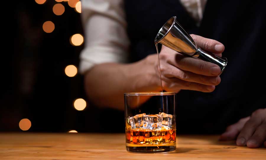 A bartender preparing a drink on the bar counter