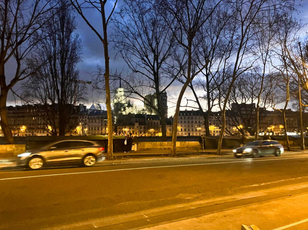 View of the cars along the road in 4th Arrondissement at night