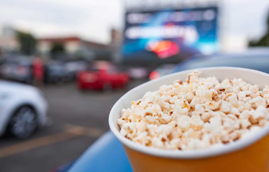 Close up view of a popcorn on a bucket while watching movie on a drive-in theatre