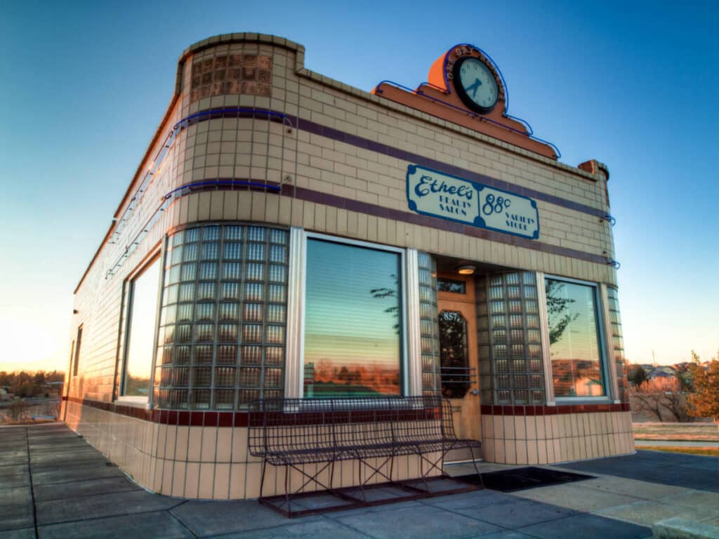 Exterior view of the 88¢ Variety Store and Ethel’s Beauty Salon at sunset