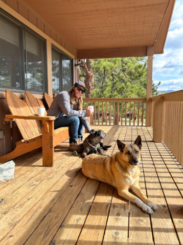 The author's husband with their dogs at the patio of their cabin at YMCA of the Rockies