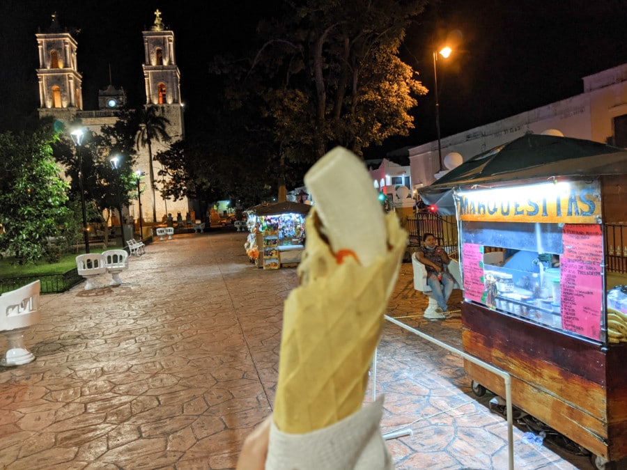 A marquesita near a vendor stand in the Valladolid city square