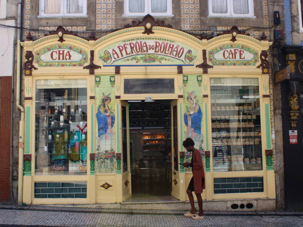 A person walking by outside A Perola a Bolhao