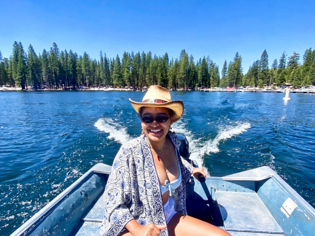 The author Laura McFarland's friend, driving the motorboat on the Pinecrest Lake