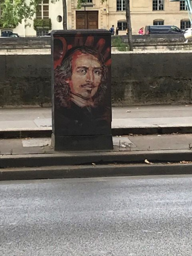 A street art in Paris featuring a painted portrait of a man