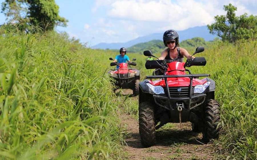 A man and a woman riding an ATV in Hacienda Campo Rico