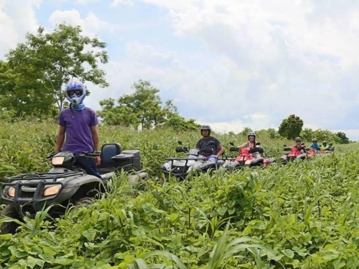 A group of tourists riding ATVs at Hacienda Campo Rico