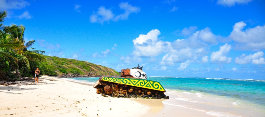 View of the abandoned military tank at the shoreline of Flamenco Beach on a sunny day