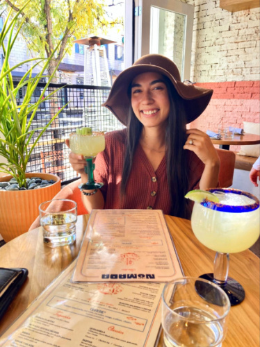 Travel Lemming Editor Abigail Bliss, holding a glass of cocktail at Lady Nomada