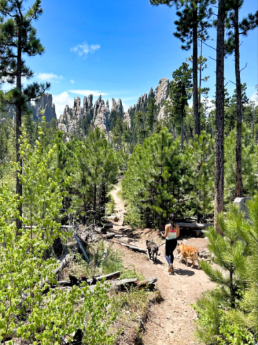 The author Abigail Bliss and her dogs, hiking along the trail at Custer State Park