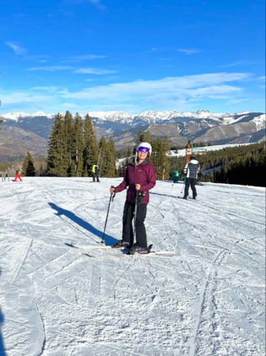 The author Abigail Bliss, posing with the mountain views in the background at Beaver Creek Resort