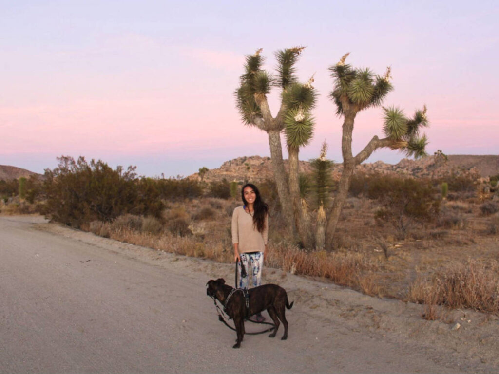 The author Abigail Bliss and her dog, posing at the trail at dusk