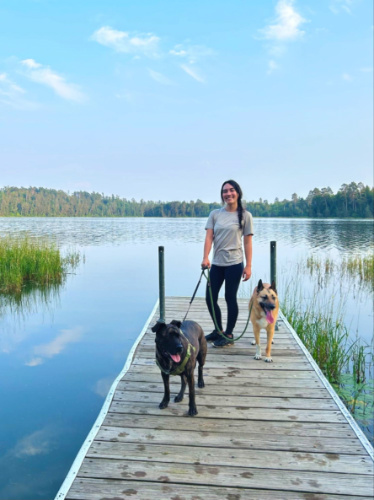 The author Abigail Bliss and her dogs, posing for a photo at the dock in Itasca State Park