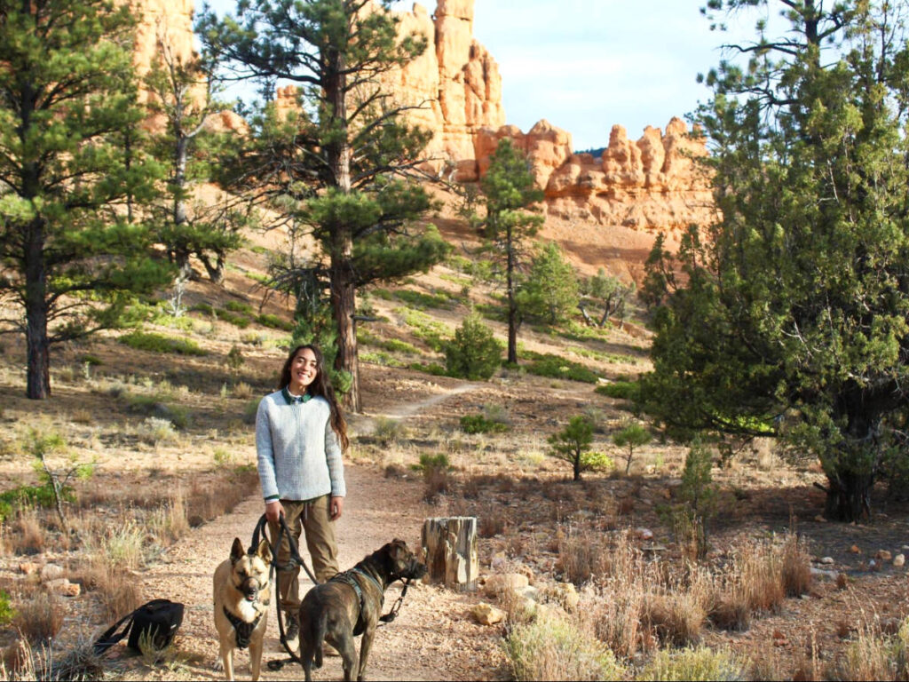 The author Abigail Bliss, posing for a photo at the trail in Red Canyon with her dogs