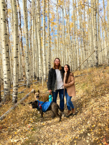 Travel Lemming editor Abigail Bliss with her husband and dogs, posing in the middle of the fall foliage at Kenosha Pass