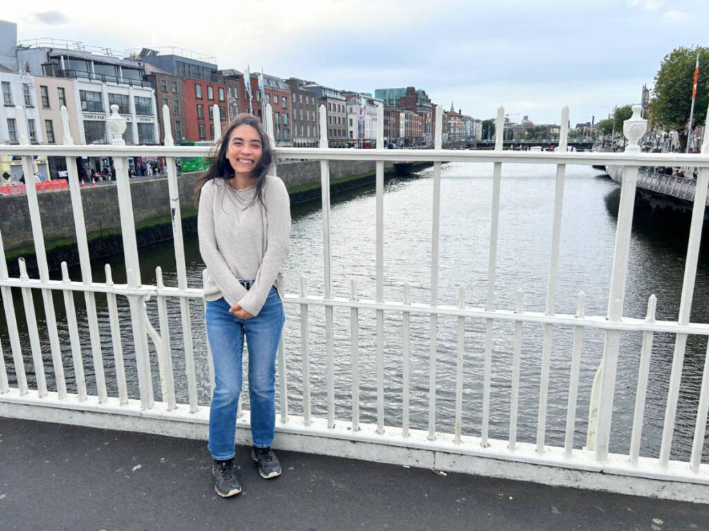 View of Abigail Bliss smiling for a photo at the Ha’Penny Bridge