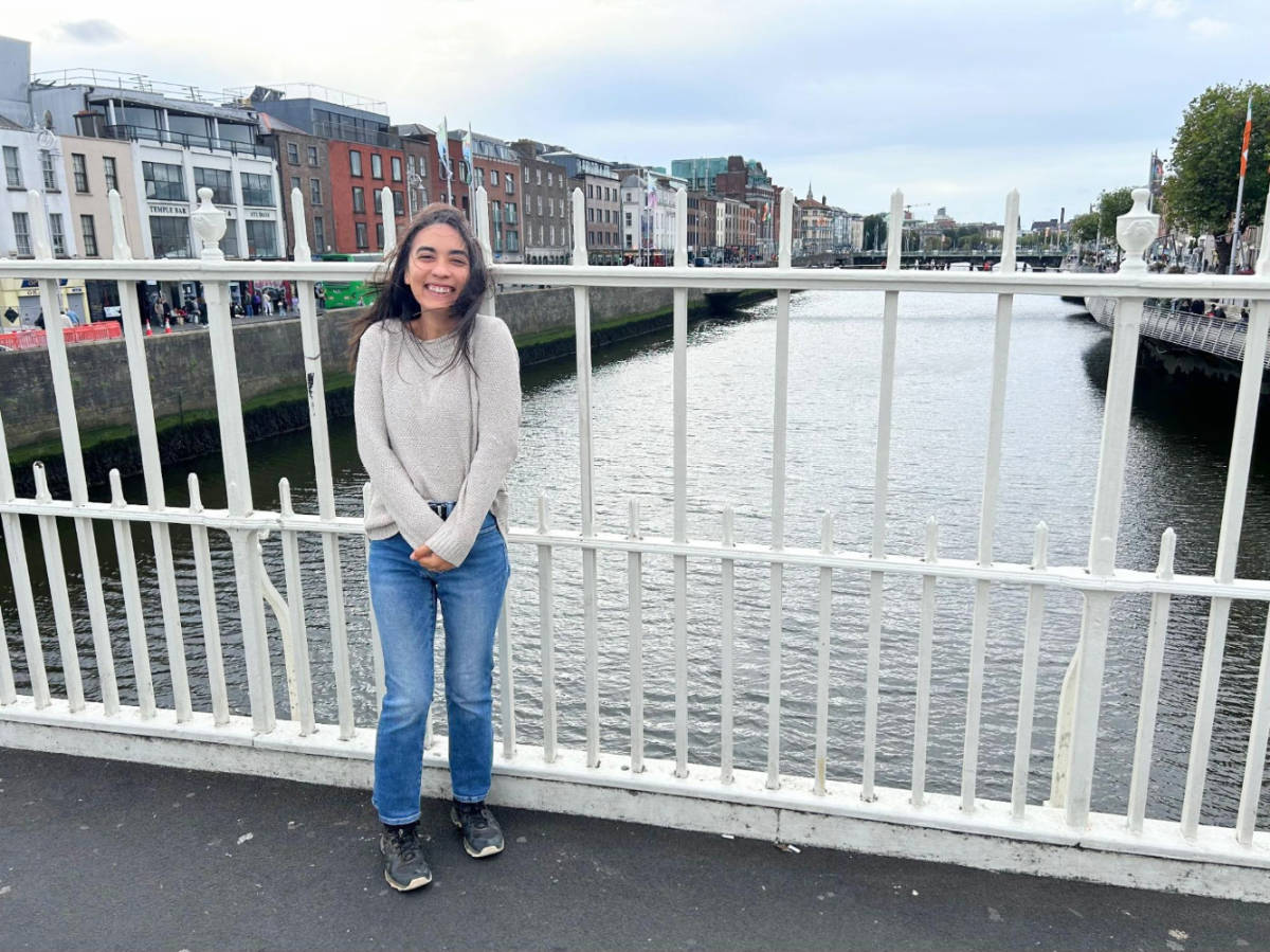 View of Abigail Bliss smiling for a photo at the Ha’Penny Bridge