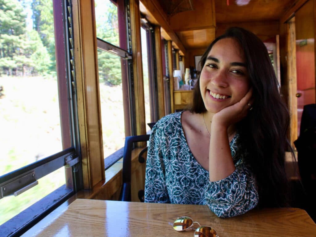 Abigail Bliss smiling for a photo while on the Cumbres and Toltec train