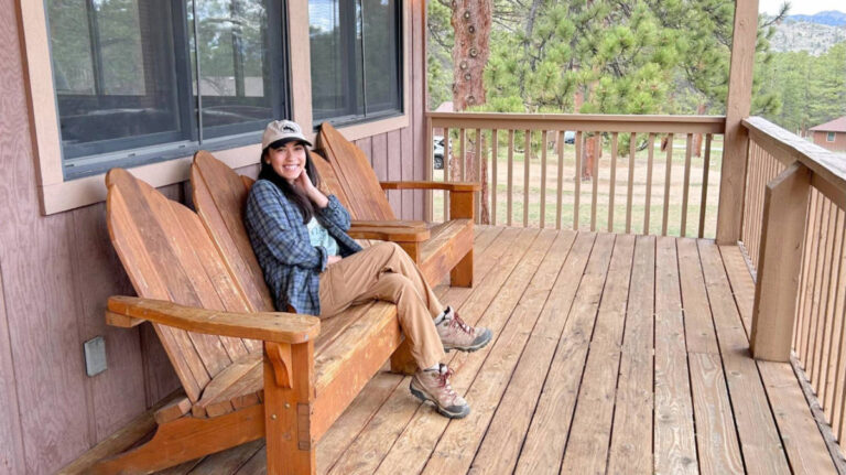 The author Abigail Bliss sitting on a patio at the YMCA of the Rockies