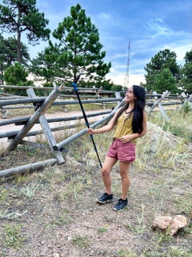 The author Abigail Bliss, using a selfie stick to take a photo