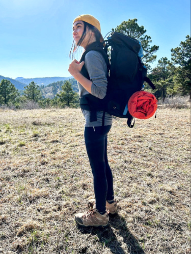 The author, Abigail posing while carrying her Teton Sports Scout Backpack during her hike on a sunny day