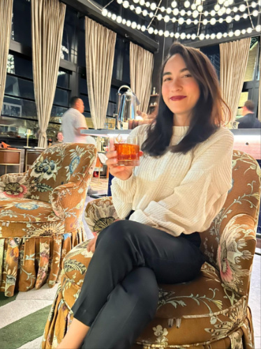 Travel Lemming Editor, Abigail holding a glass of cocktail at Call Me Pearl