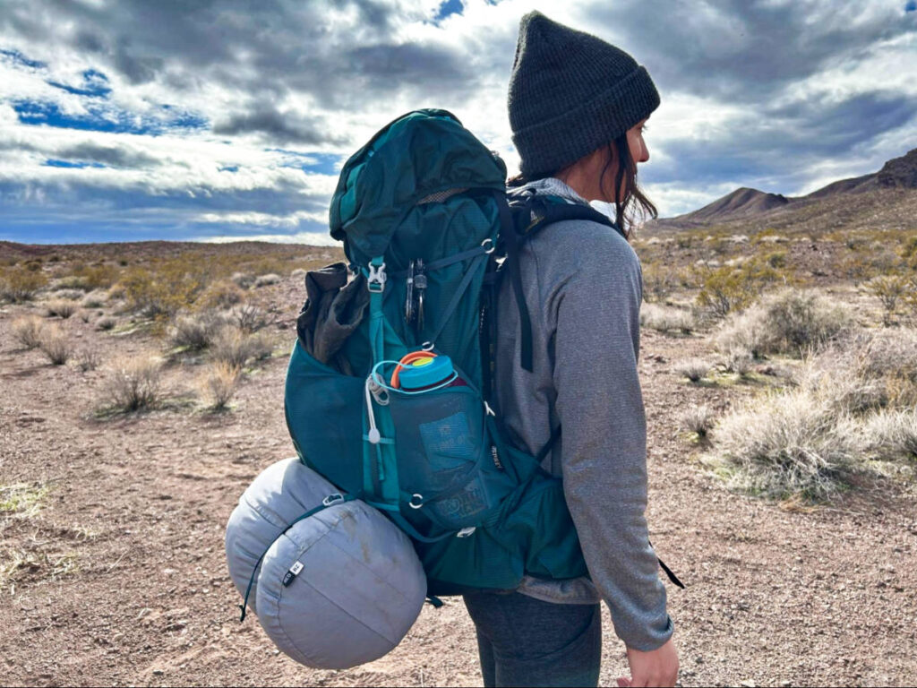 Abigail showing the side view of her Osprey Eja Backpack