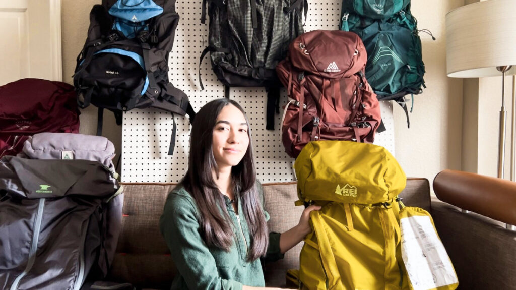 The author, Abigail, posing with her REI backpacks in the background