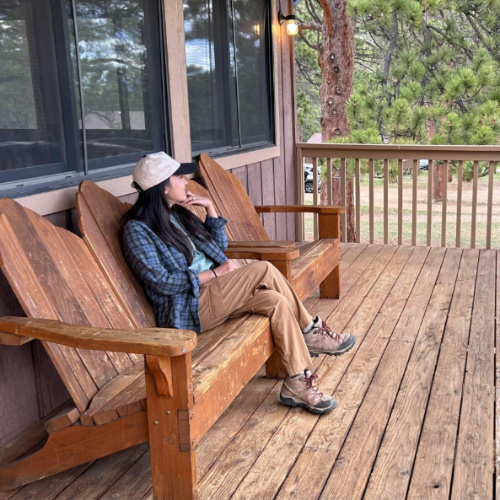 The author Abigail Bliss sitting on the front porch bench