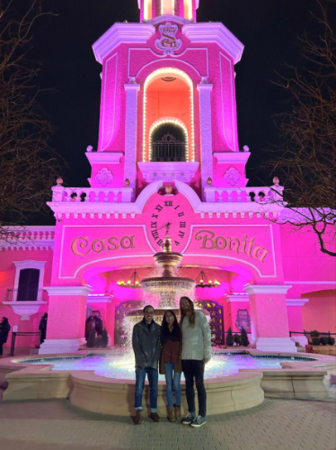 The author Abigail Bliss and her family posing for a photo outside the Casa Bonita