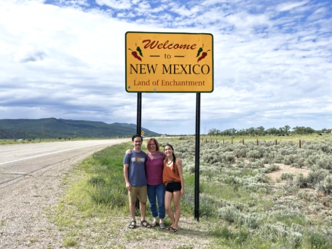 Travel Lemming Editor Abigail and her family posing at the state line