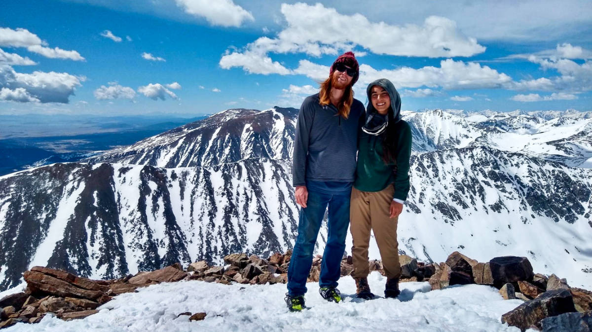 Travel Lemming editor Abigail Bliss and her husband, posing for a photo at the snowy Quandary Peak