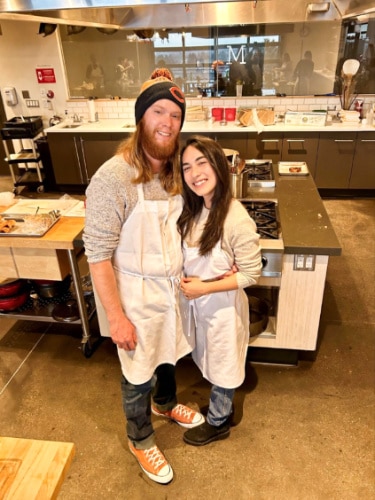 Travel Lemming editor Abigail Bliss with her husband posing at the workstation of Uncorked Kitchen & Wine Bar