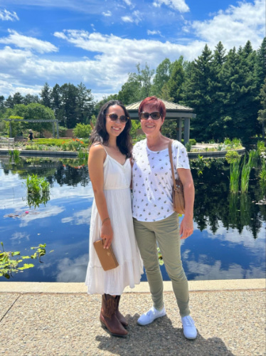 The author Abigail and her mom posing for a photo backdropped by the Monet Pool