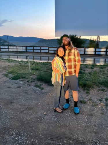 The author Abigail and her husband at the Holiday Twin drive-in at dusk