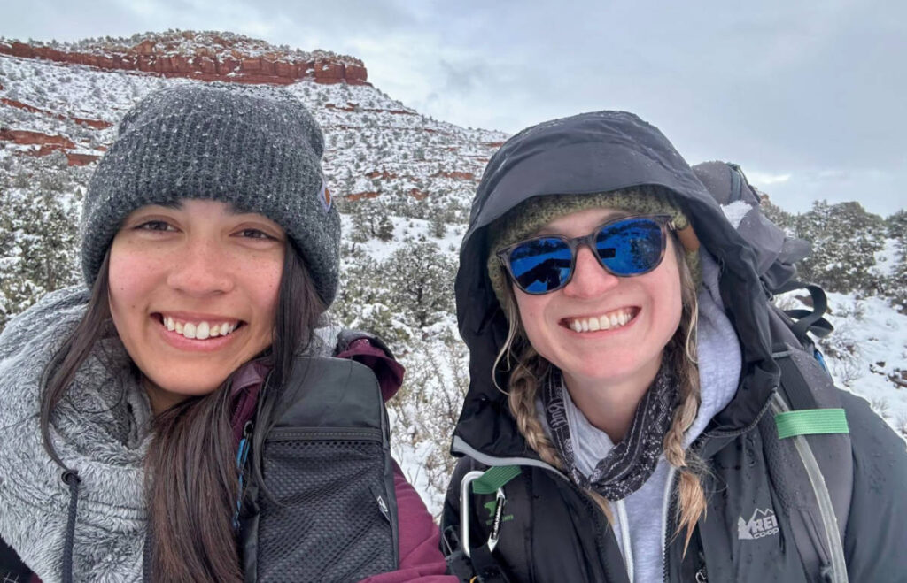The author and Skycie smiling for a photo during a winter trip