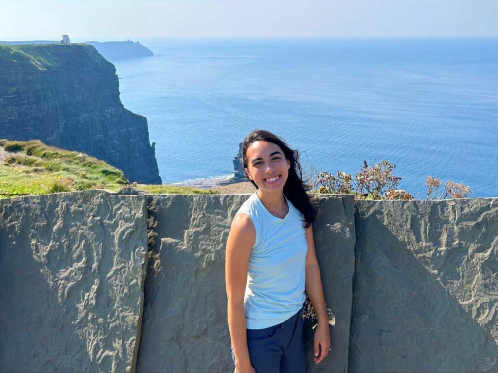 The author Abigail posing for a photo at the coastal walk of Cliffs of Moher