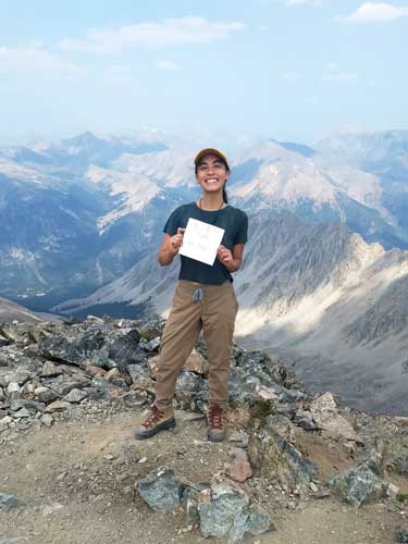 Abigail Bliss at the top of La Plata Peak with overlooking view
