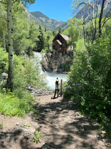 The author Abigail taking a photo of the Crystal Mill in the middle of the greenery
