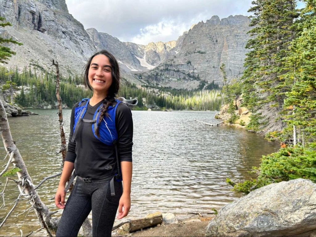 The author Abigail with the scenic views on the trail to Sky Pond