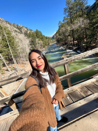 Abigail taking a selfie on a wooden bridge