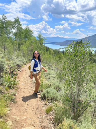 The author Abigail at the trail with scenic Twin Lakes view behind