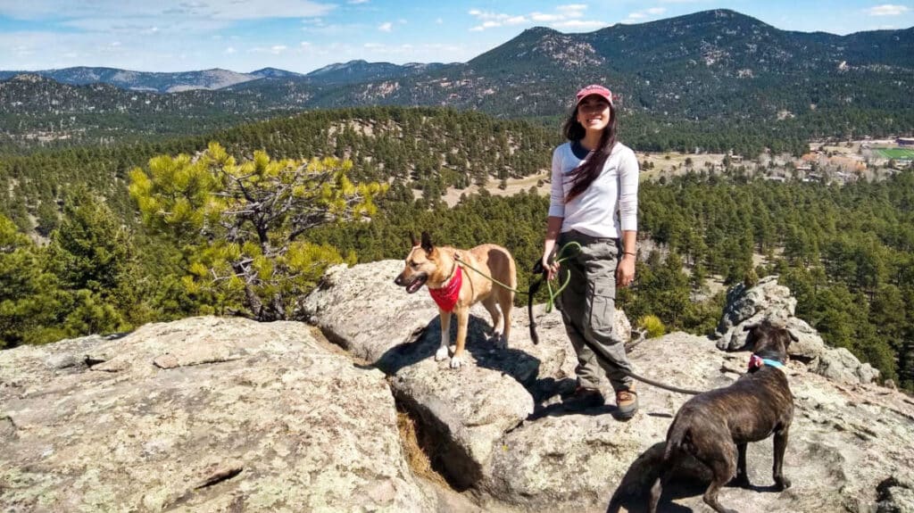 Travel Lemming editor Abigail Bliss with her dogs posing on the Evergreen Mountain summit 