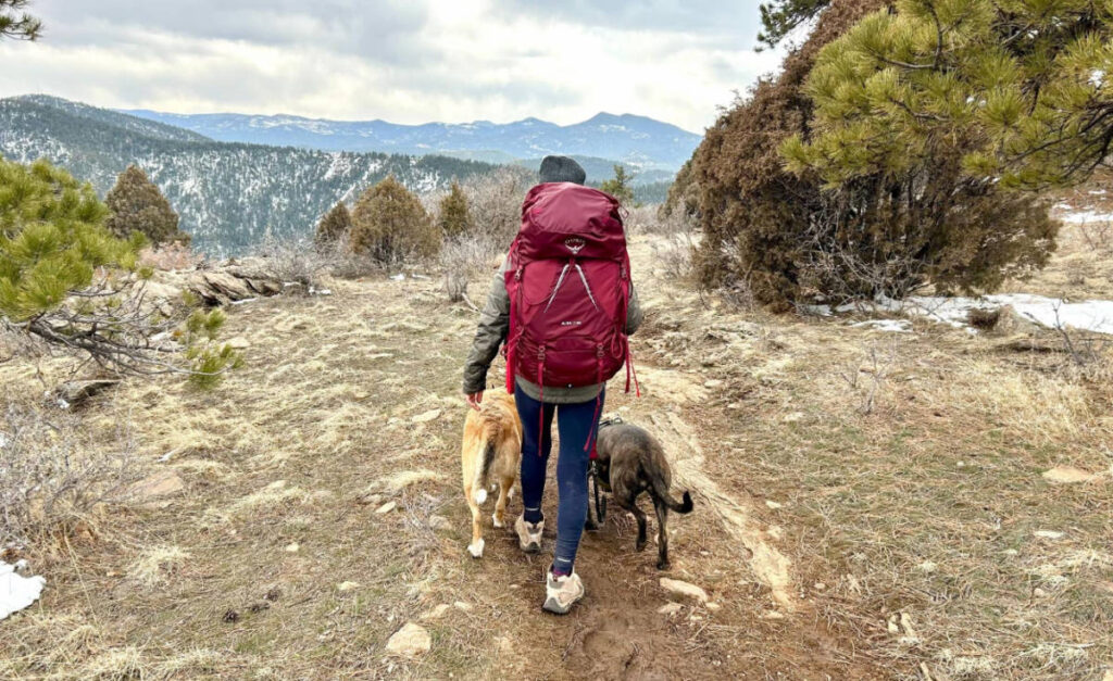 The author with her dogs during a hike while using the Osprey Aura AG LT 65 backpack