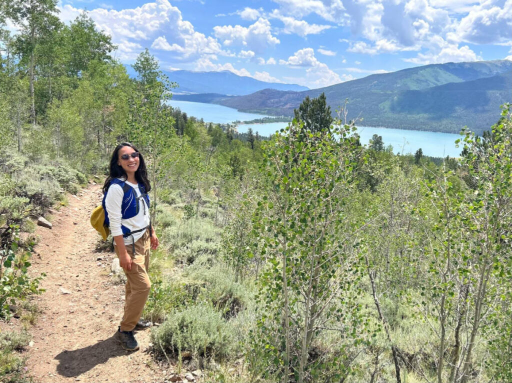 The author Abigail Bliss posing for a photo with the Twin Lakes in the background