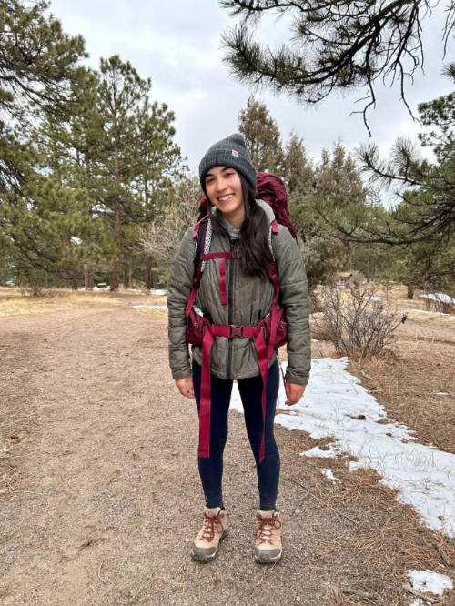 Abigail smiling for a photo while carrying her Osprey Aura AG LT 65