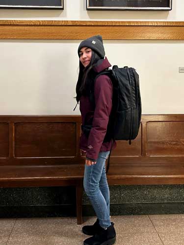 Abigail carrying the Tortuga Travel Backpack