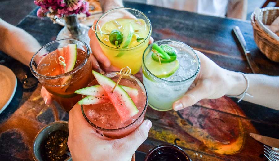 Group of friends having a toast with their cocktails in Across the Pond
