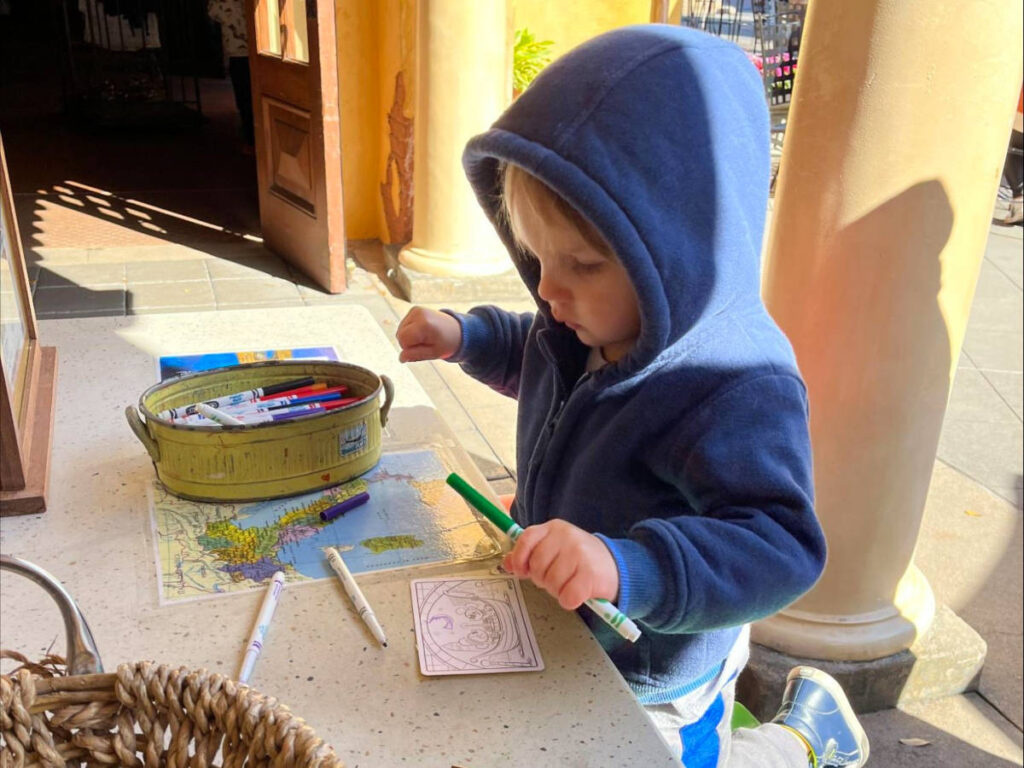 Author Katie's son coloring at a Kidcot Fun Stop