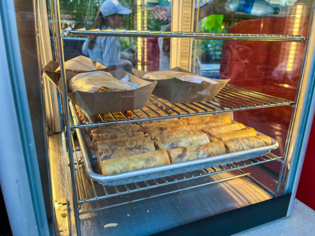 Delicious spring rolls on display at Adventureland Spring Roll Cart